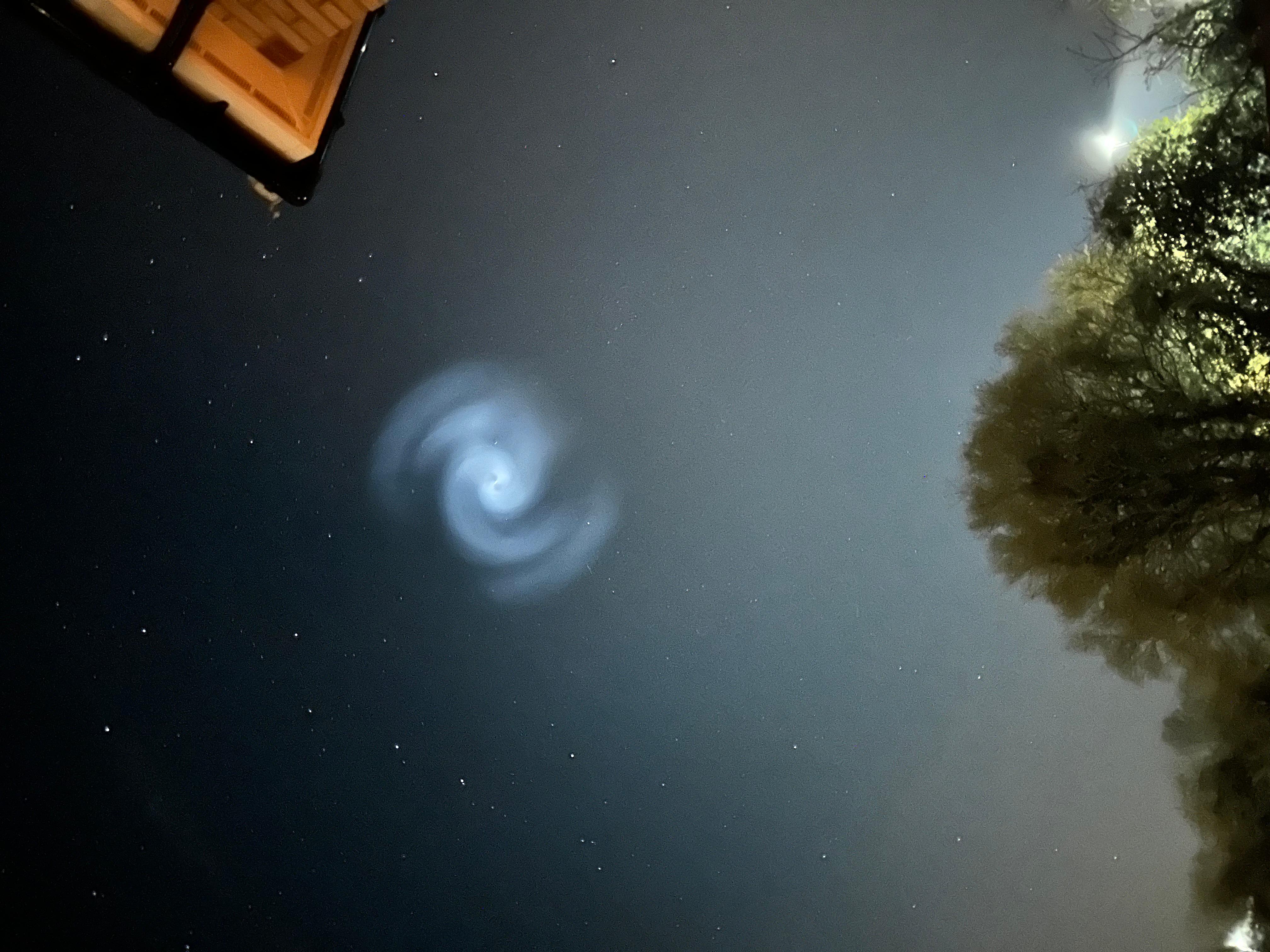 Bright white light changing shape slowly moving across sky